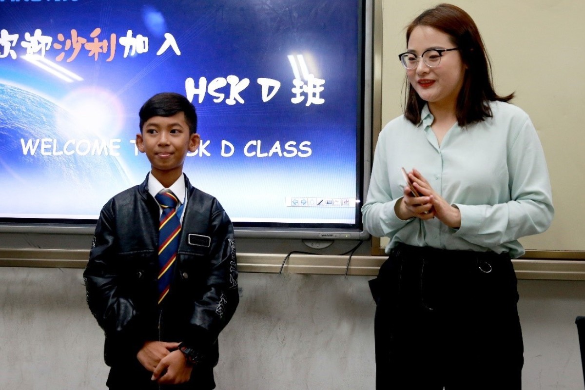 Thuch Salik is welcomed to class at Hailiang Foreign Language School in Zhuji, Zhejiang, where staff say he is adapting well to life and education in China. Photo: Handout