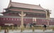 A man wears a face mask as he rides a bicycle past Tiananmen Gate in Beijing. Photo: AP