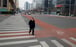 A man crosses the road in the practically deserted central business district in Beijing on February 24. Photo: Reuters