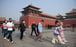 People wear face masks amid concerns of the coronavirus as they walk to the entrance of the Forbidden City in Beijing. Photo: AFP