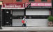A woman walks by closed shops in Brooklyn, New York City on May 5. Photo: AFP