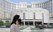 A woman walks past the headquarters of the People’s Bank of China in Beijing in 2018. The Chinese central bank’s refusal to embrace the expansionist monetary policy of its peers has left it more options as the country’s recovery from Covid-19 continues. Photo: Reuters