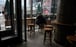 A lone customer sits in an empty cafe in Beijing on February 5, as China fights to contain the coronavirus outbreak. Photo: AFP