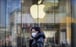 A woman wearing a mask walks past a temporarily closed Apple store in Beijing on February 4. The American tech giant has closed all stores in China due to the coronavirus outbreak. Photo: AP