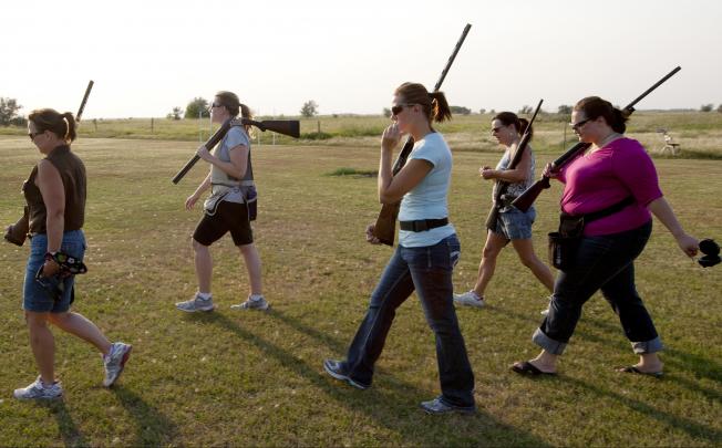 Shooters hike to a station during an instructional women's shooting league at the Dakota Hunting Club in Grand Forks, North Dakota. Eric Hylden/Grand Forks Herald/MCT