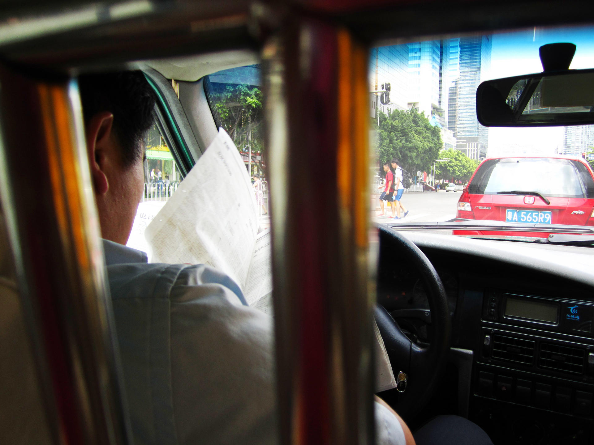 Driven to distraction:A taxi driver catches up on the day's news at 60km/h.