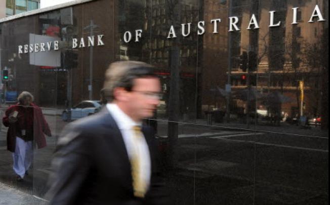 A businessman passes the Reserve Bank of Australia ( RBA) in Sydney. AFP: Torsten Blackwood