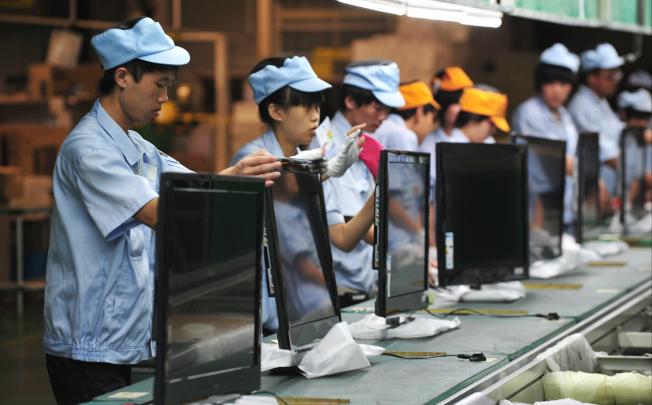 Chinese workers labouring on a television set assembly line in a factory in Shenyang, Liaoning Province, China, 27 August 2012. EPA
