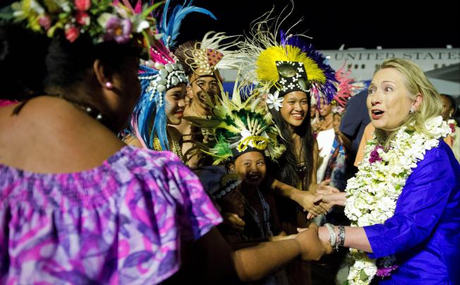 US Secretary of State Hillary Rodham Clinton, right, is greeted upon her arrival at Rarotonga International Airport. Photo: AP