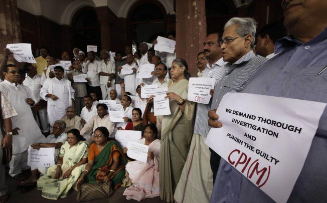 Indian lawmakers shout slogans during a protest at the parliament house, in New Delhi, on Friday. Photo: AP