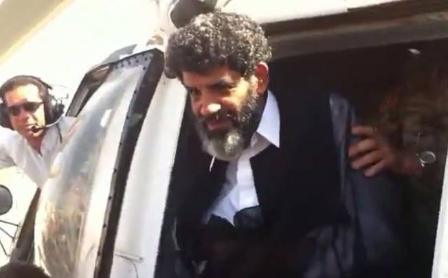 Former spy chief Abdullah al-Senussi arrives in Tripoli on Wednesday, in this video grab. Photo: AFP