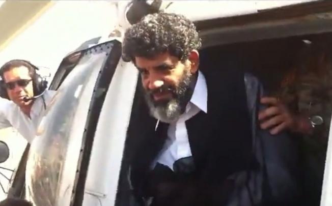 A video grab shows Abdullah al-Senussi arriving at the high security prison facility in Tripoli on Wednesday. Photo: AFP