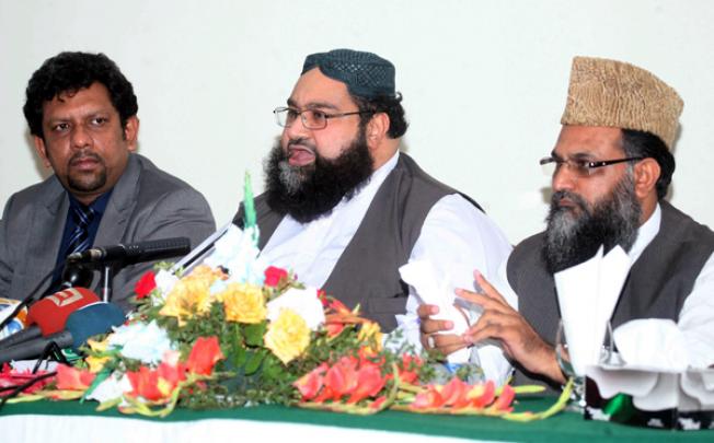 Tahir Ashrafi, centre, chairman of the All Pakistan Ulema Council, addresses a press conference in Islamabad on Monday. Ashrafi urged the government to set up a team, including intelligence agents, to get to the bottom of the conspiracy and expose the real culprits' in the Rimsha Masih case. Photo EPA