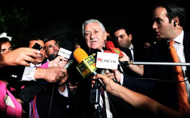 Fotis Kouvelis, leader of the Democratic Left party, addresses the media after a meeting with Greek coalition party leaders in Athens on Sunday. Photo: AP