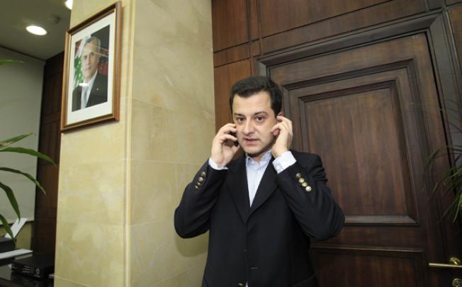 Turkish national Aydin Tufan Tekin, who was abducted by gunmen of Lebanon's Muqdad clan, phones after being handed to the Turkish Ambassador to Lebanon at the Lebanese General Security headquarters in Beirut on Tuesday. Photo: AFP 