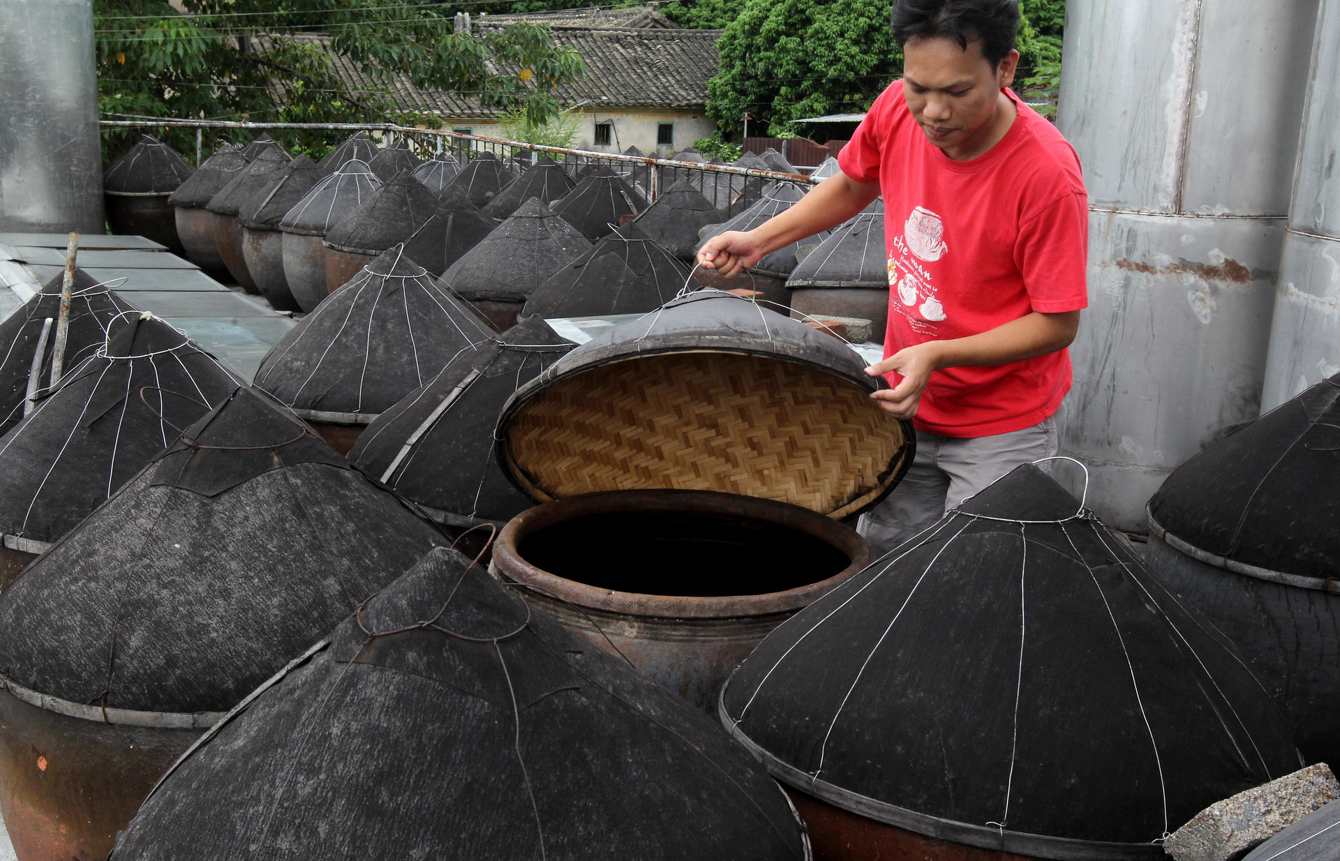  A worker checks vats at one of Kwu Tung's soy sauce factories. Photo: K.Y. Cheng