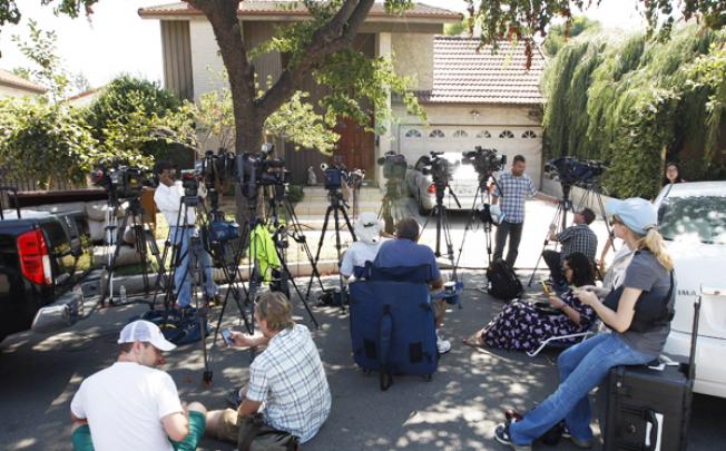 Reporters gather outside the house of a man thought to be associated with the production of the anti-Muslim movie, 'Innocence of Muslims', on Thursday in Cerritos, California. Photo: AFP