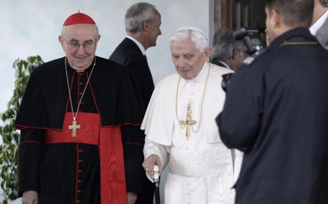Pope Benedict XVI, center, with cardinal vicar Agostino Vallini, left, arrives to board a plane to Lebanon, at the Ciampino military airport, near Rome, on Friday. Photo: AP