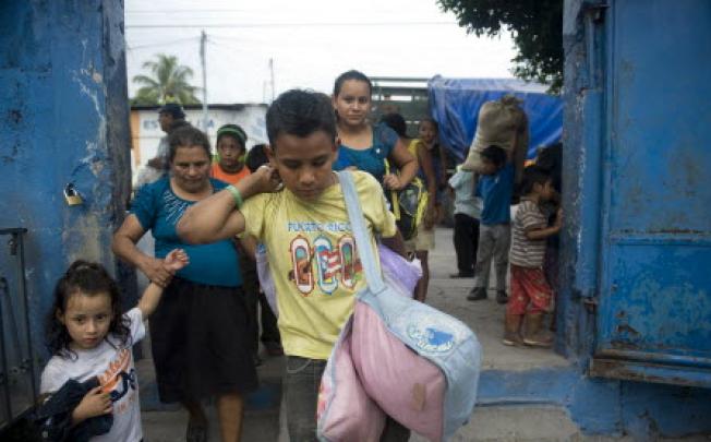 People evacuated from Morazan arrive at a shelter in a school of Santa Lucia Cotzumalguapa, 90km south of Guatemala City after their village was affected by ash released by the Volcan de Fuego. Guatemala's Volcano of Fire had its strongest eruption in a decade on Thursday. Photo: AFP