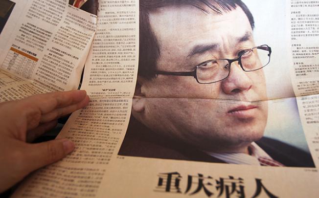 A picture of Wang Lijun is splashed across The Economic Observer after he fled to the US consulate in Chongqing in February. Photo: Simon Song