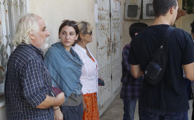 Friends of killed Italian Vittorio Arrigoni stand inside the grounds of the military court building which belonging to Hamas movement in Gaza City, on Monday. Photo: AFP