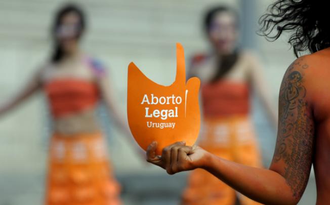 Pro abortion activists demonstrate in front of the Uruguayan congress in Montevideo on Tuesday. Photo: AP