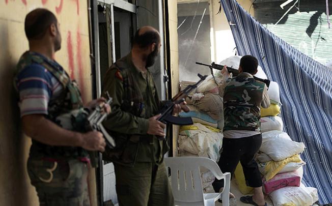 Syrian rebel fighters take their position in Salaheddine neighbourhood of Aleppo on Wednesday. Photo: AFP