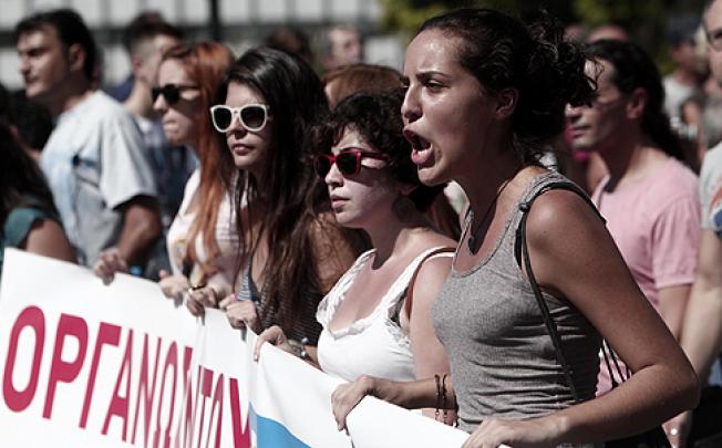 Protesters last week march in front of the Greek Parliament against austerity measures. Photo: AP