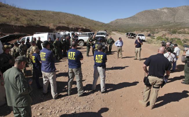 Law enforcement officers gather at a command post in the desert near Naco, Arizona, on Tuesday. Photo: AP