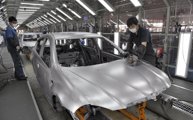 A production line at Brilliance China Automotive in Shenyang. Shares in the carmaker, which makes BMW cars, rose 5.9 per cent yesterday. Photo: EPA