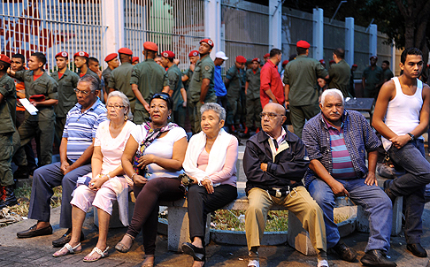 Venezuelans wait outside a polling station before voting in Caracas on Sunday. Photo: AFP