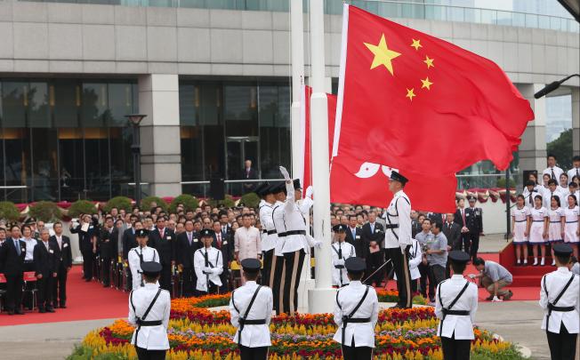 People attend a flag raising ceremony at the Golden Bauhinia Square in Hong Kong on Oct. 1, 2012. Photo: SCMP
