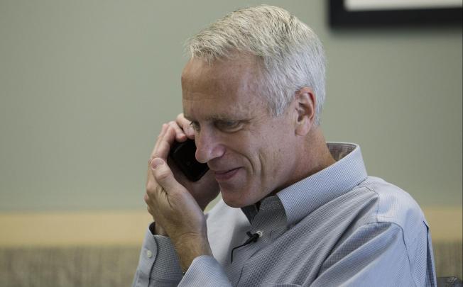 Brian Kobilka talks on the phone after being awarded the prize. Photo: AFP