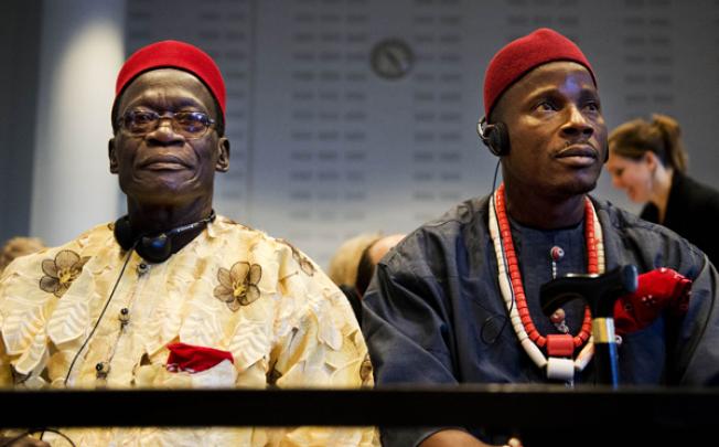 Nigerian farmers Chief Fidelis A Oguru-Oruma (left) and Eric Dooh sit in the law courts in The Hague on Thursday. Photo: AFP