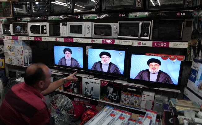 A Palestinian man in a shop in Gaza watches Hezbollah leader Hassan Nasrallah's speech, broadcast by the group's Al-Manar TV. Photo: Xinhua