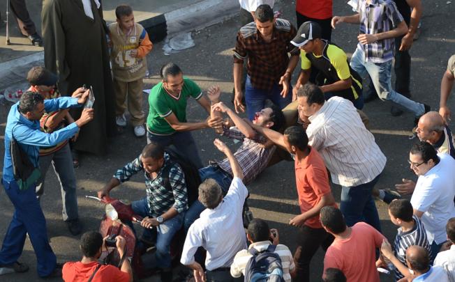 Supporters of Mohammed Mursi clash with liberal and leftist protesters in Cairo. Photo: AFP