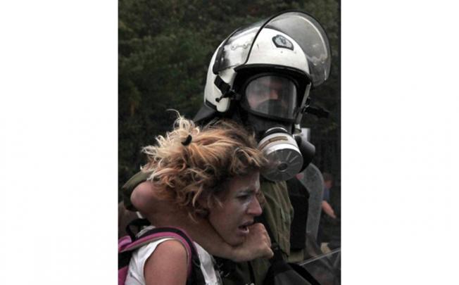 The officer with his arm around the distressed protester’s neck.