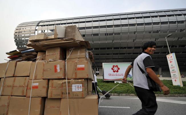 A working staff carries materials for the preparation of the 112th China Import and Export Fair, or Canton Fair, in Guangzhou.
