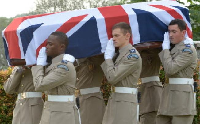 British Royal Air Force officers carry a coffin containing the remains of eight World War II crew members during a reburial ceremony in Kuala Lumpur on Thursday. Photo: AFP