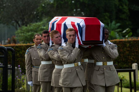 Members of the Queen's Colour Squadron carry a coffin of World War II plane crash victims during a reburial ceremony, in Kuala Lumpur, Malaysia, on Thursday. Photo: EPA