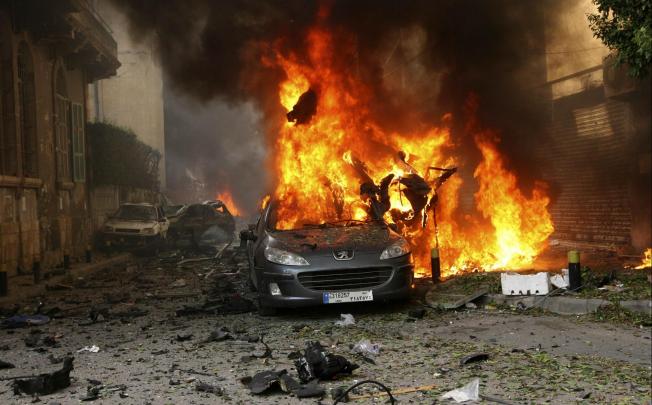 A car burns after an explosion in east Beirut. The blast damaged cars and destroyed the front of a multi-storey building. Photo: Reuters