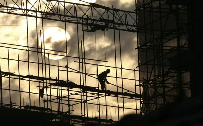 A labourer works on a construction site. The Hongqiao CBD project in Shanghai is aiming to lure multinational companies. Photo: Reuters