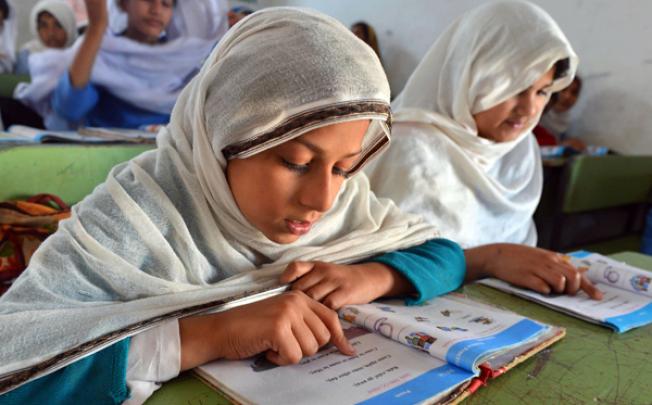Pakistani female students attend a class at a government school in Peshawar. Photo: AFP