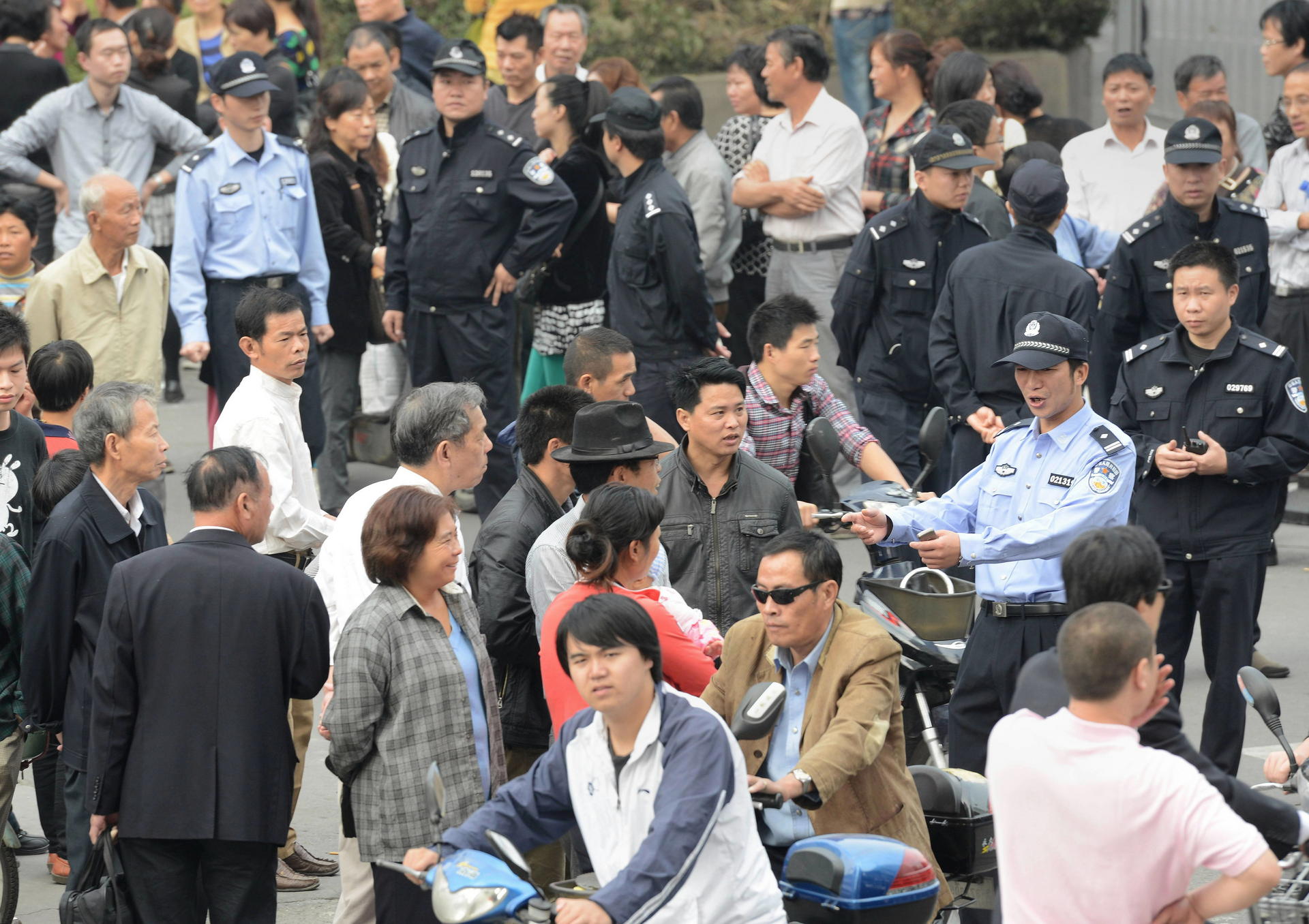 Residents gather outside the Ningbo city government offices yesterday. Officials say the 55.8-billion-yuan expansion has been suspended pending "scientific debate". Photo: AFP