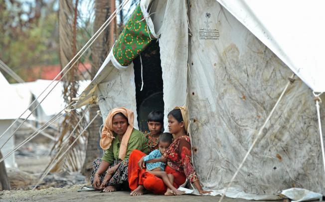A Muslim Rohingya family sits outside their temporary shelter at a village in Minpyar, Rakhine state. At least 88 people have been killed in sectarian violence this month, with more than 26,000 others forcefully displaced.  Photo: AFP 