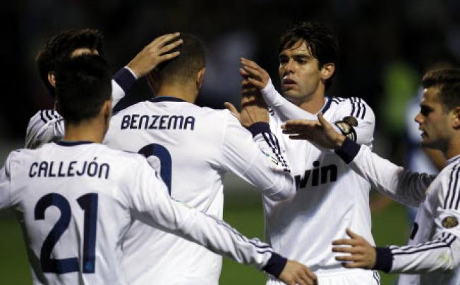 Real Madrid's Karim Benzema from France (centre) is congratulated by teammate Kaka (second right) after scoring against Alcoyano during their Copa del Rey match. Photo: AP