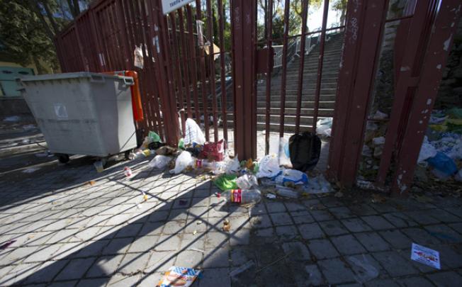 Empty bottles and other debris lie outside the closed gates of the Madrid Arena venue in Madrid on Thursday. Photo: AP