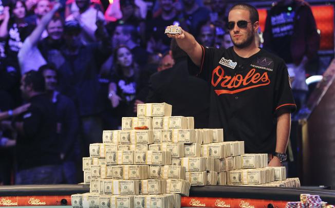 Greg Merson holds up his new bracelet after winning the World Series of Poker No-Limit Hold'em Main Event. Photo: AP