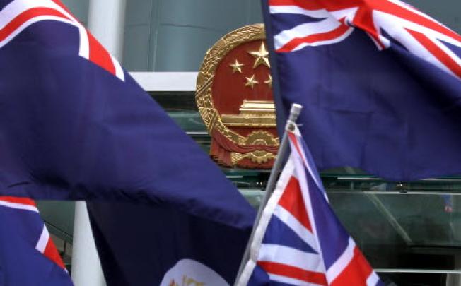 Members of "We are Hongkongers, Not Chinese" wave Hong Kong Flag of the colonial era in front of Central Government's Liason Office on 1st October 2012. Photo:SCMP