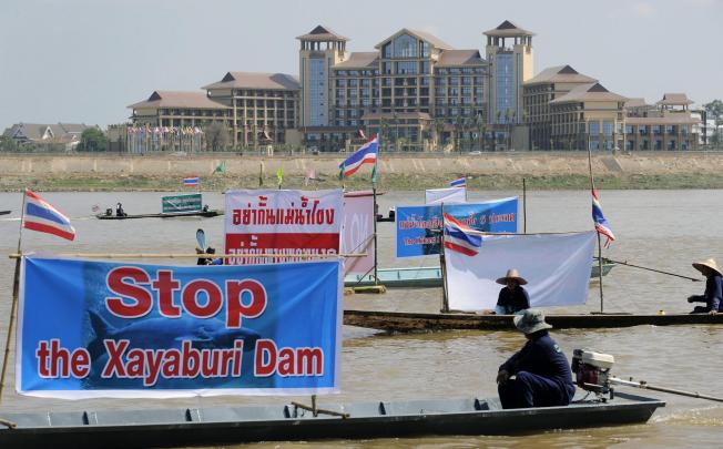 Thai activists and villagers protest opposite Laos. Photo: EPA